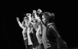 Modern dancers bow at end of performance